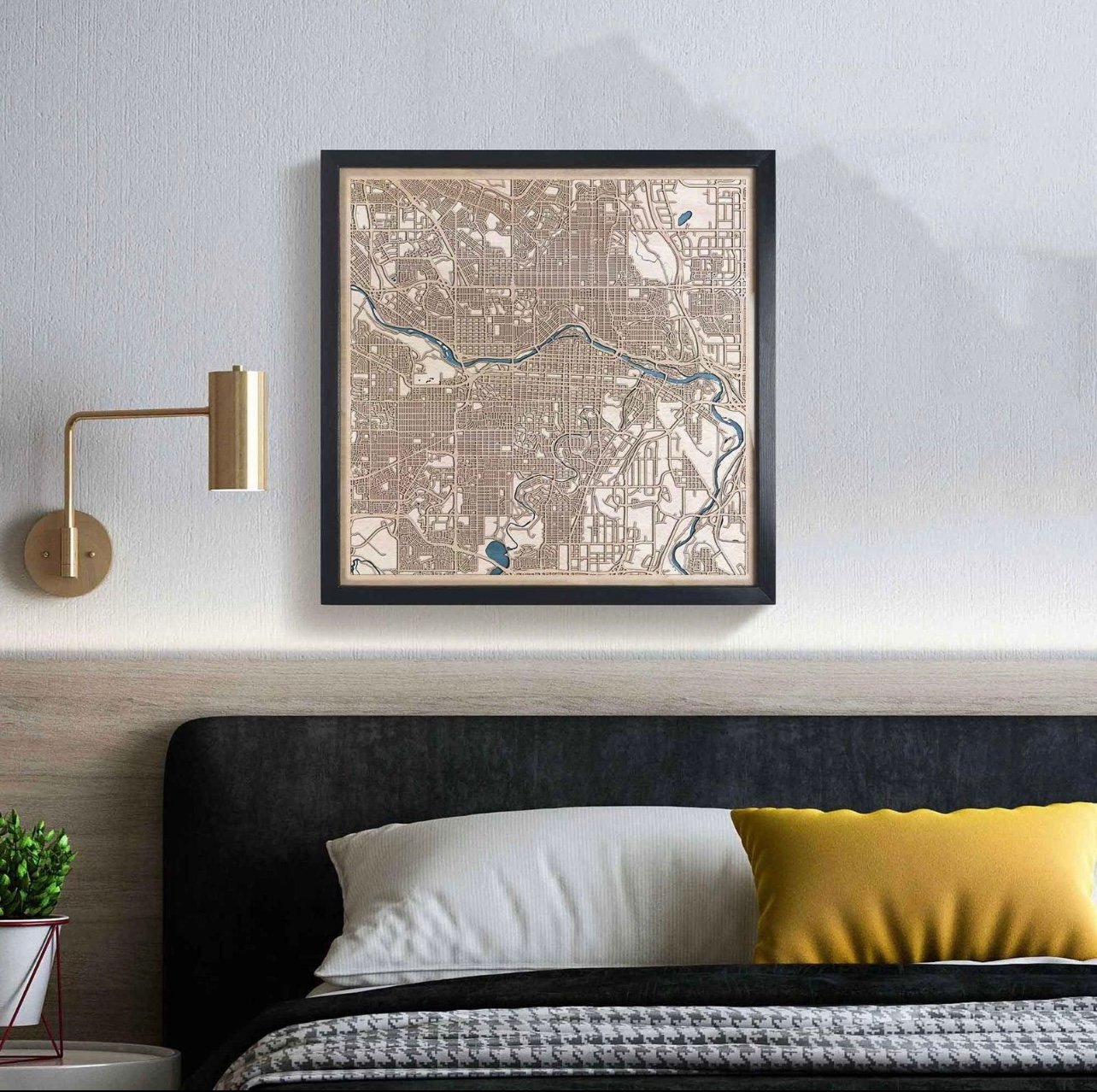 Premium framed wooden city map above a styled bedroom